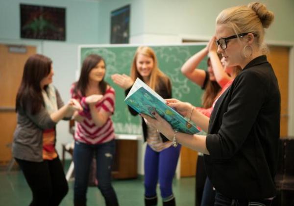 Female students and professor working together in a classroom