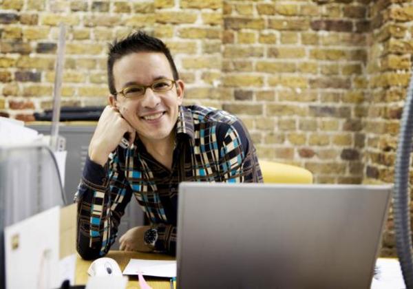 Smiling young man in a computer lab