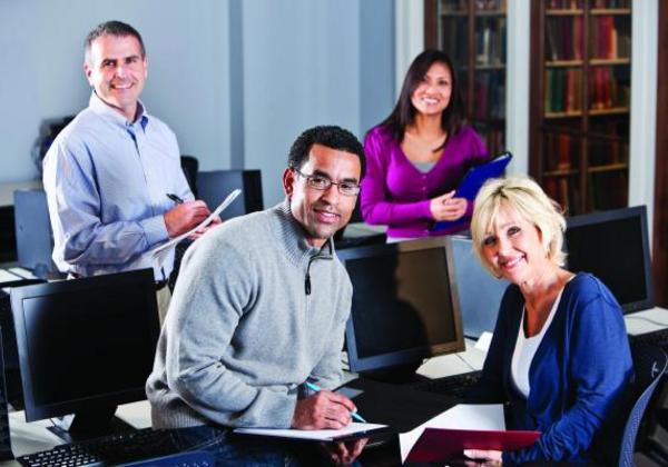 Smiling students and school faculty