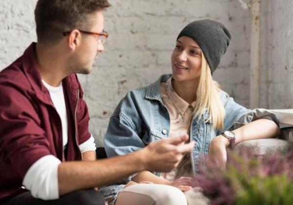 Male and female student working together