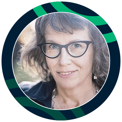 Smiling woman with brown hair wearing glasses